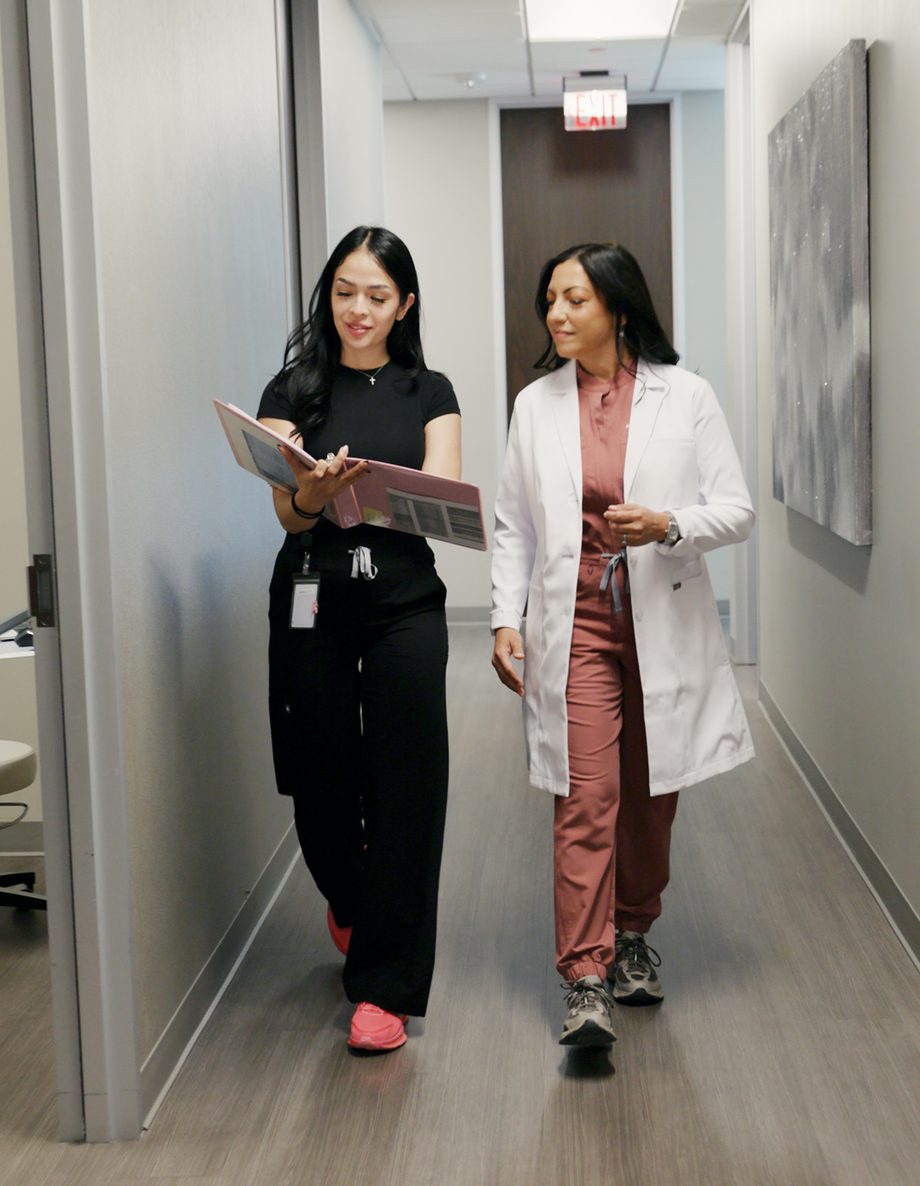 Dr. Vega walking with a member of the care team